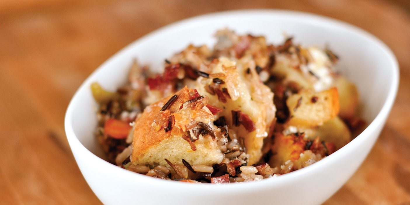 A photo of stuffing and rice in a white bowl.