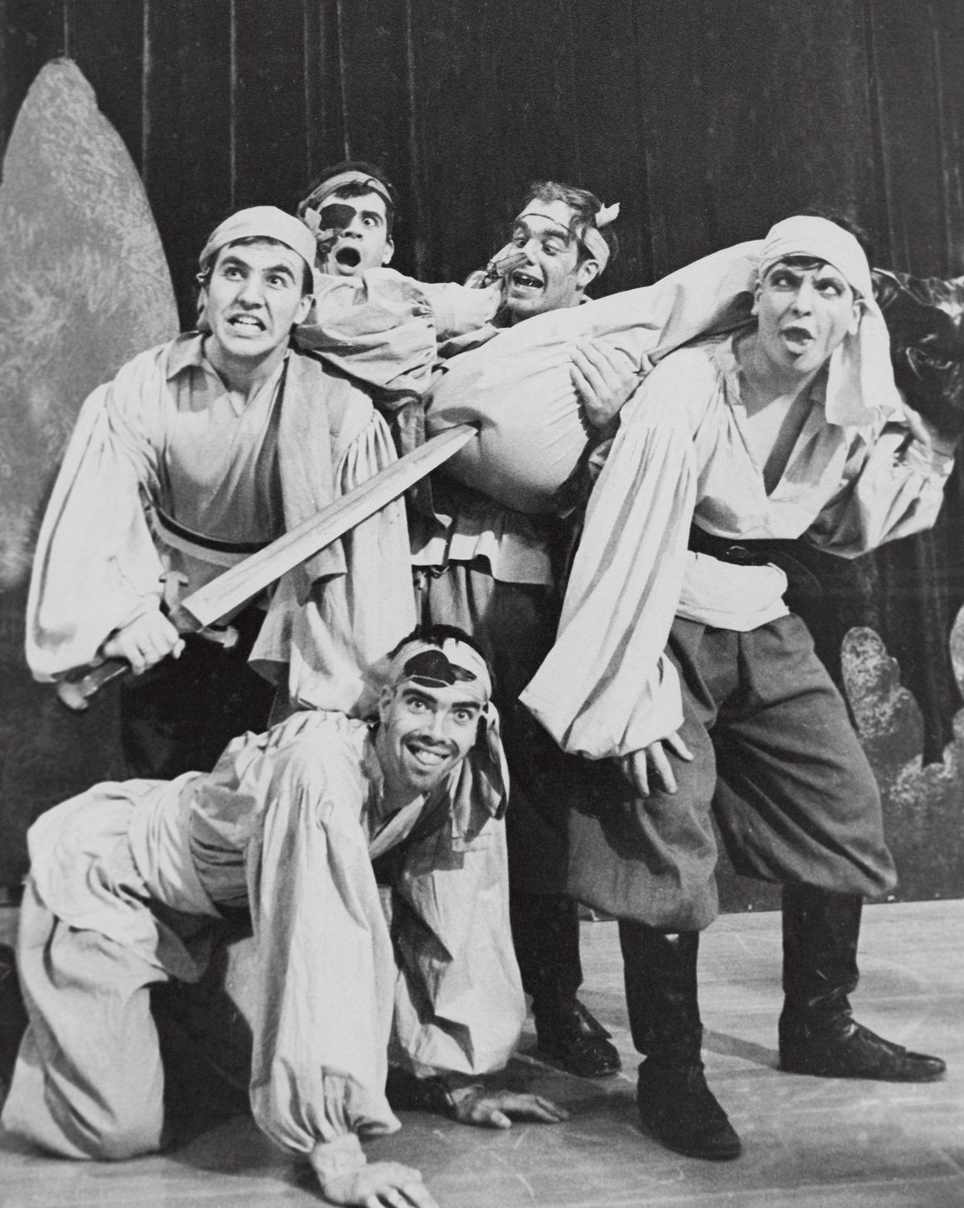 A black and white photo from the 1960s of a group of male BYU students dressed as pirates making funny faces.
