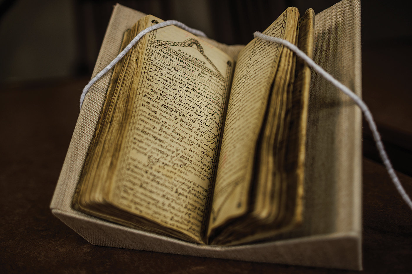 Old journal laid open with written text visible on the pages