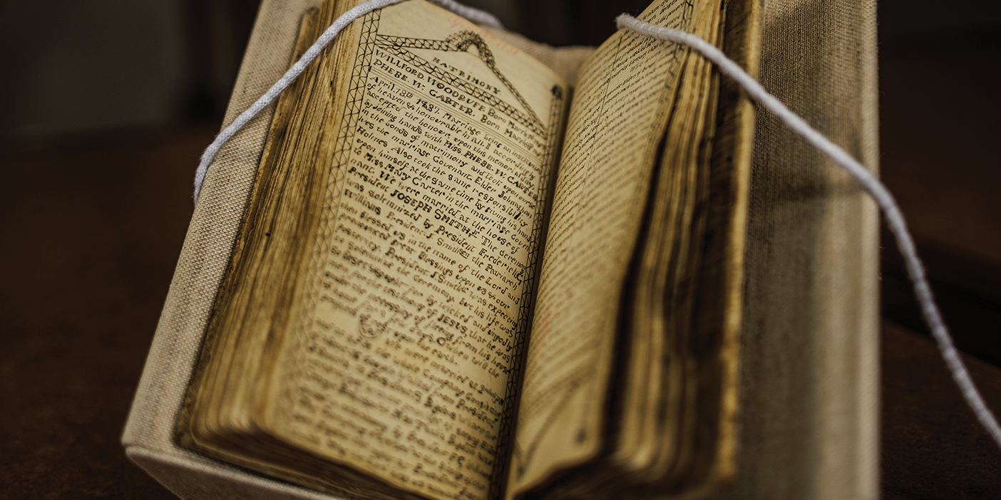 Old journal laid open with written text visible on the pages