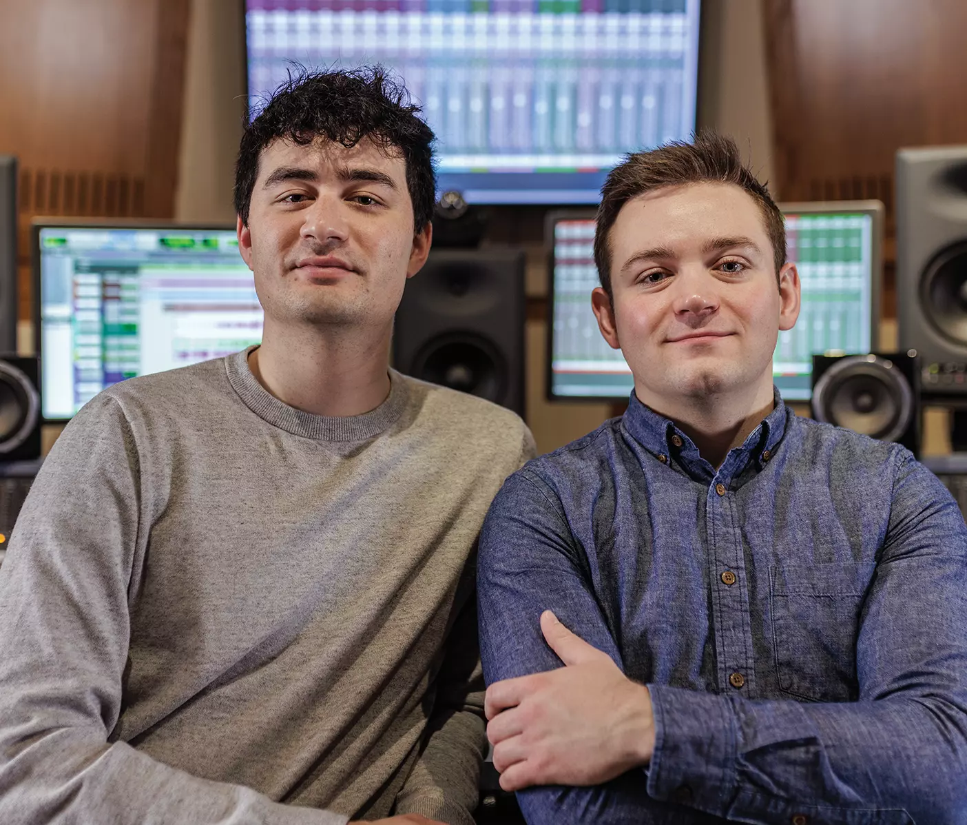 Vocal Point beatboxer Alex Brown and tenor Jaren McMillan stand in a recording studio.