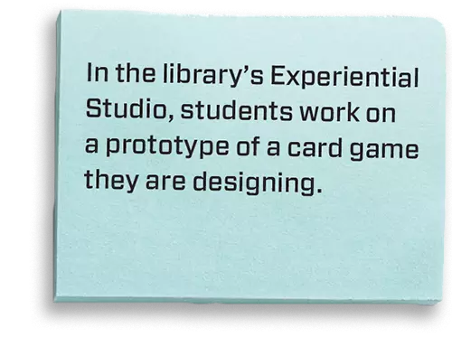 In the library’s Experiential Studio, students work on a prototype of a card game they are designing.