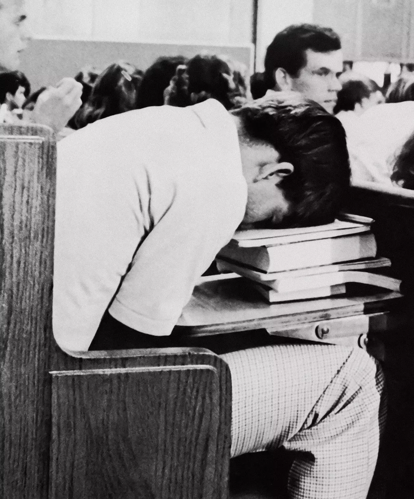 A student dressed in 1980s clothes sleeps on his desk in the Joseph Smith Building.