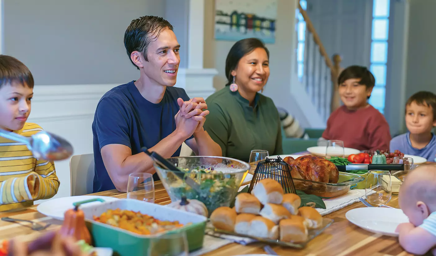 A family gathers at the dinner table to share time, stories, and food.