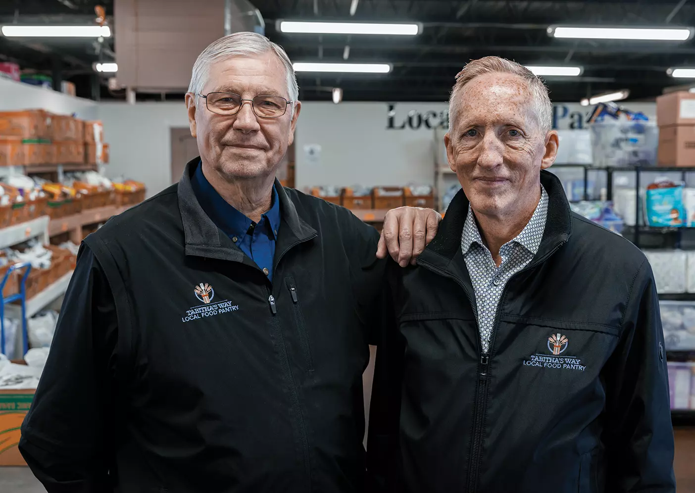 Al Switzler and Mike Carter pose with food and basic necessities collected for those in need.