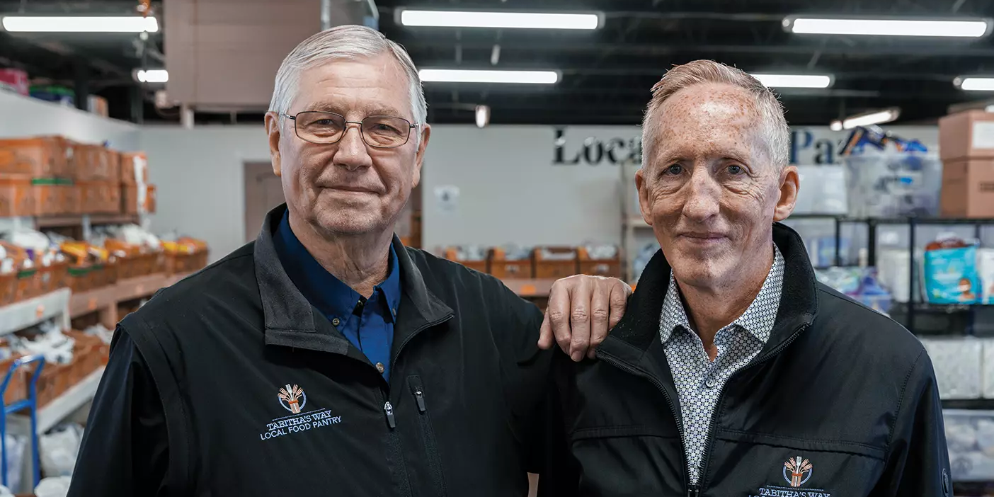 Al Switzler and Mike Carter pose with food and basic necessities collected for those in need.