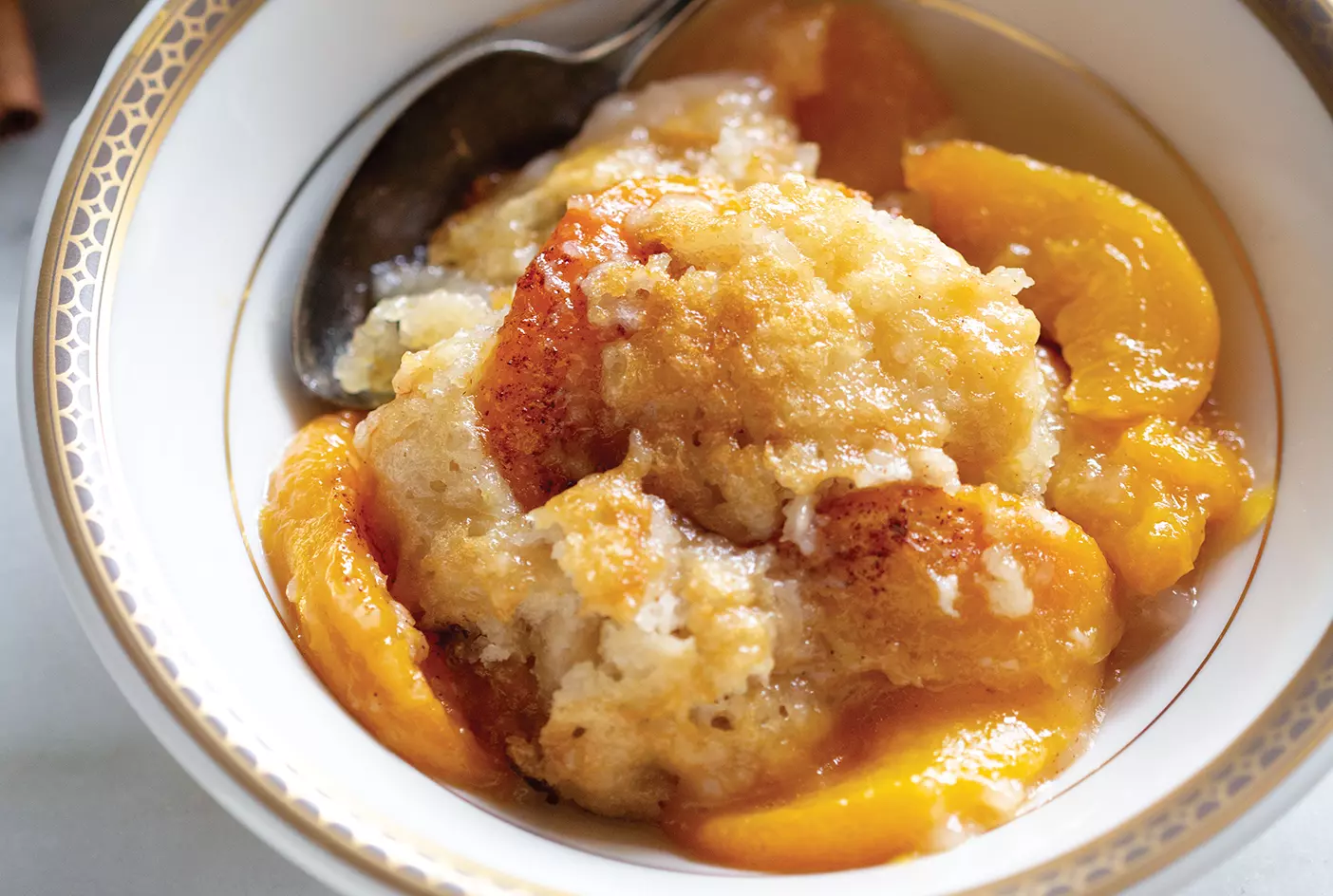 A bowl of peach cobbler.