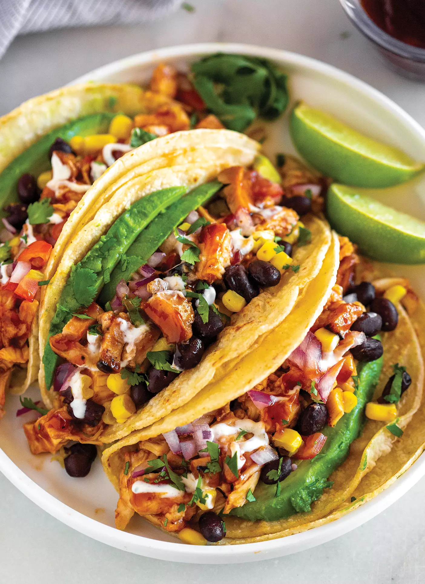 A plate of tacos made with BBQ chicken