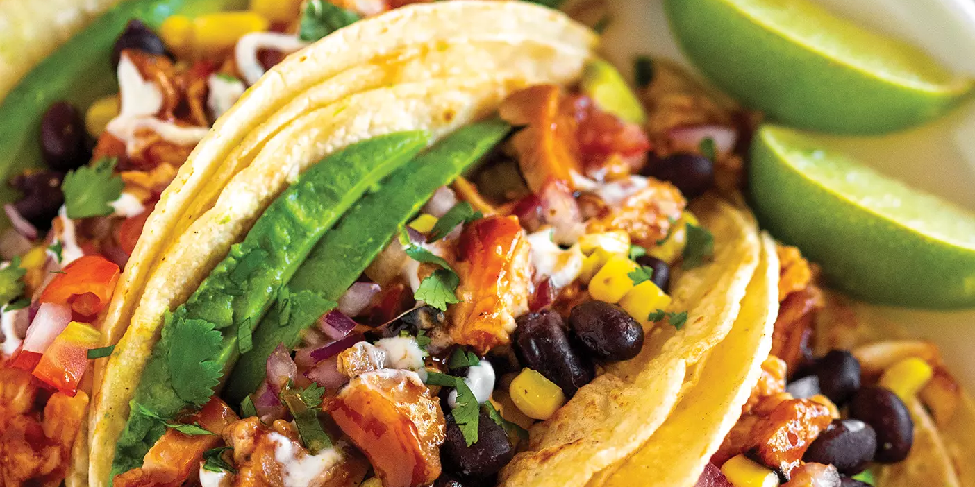 A plate of tacos made with BBQ chicken