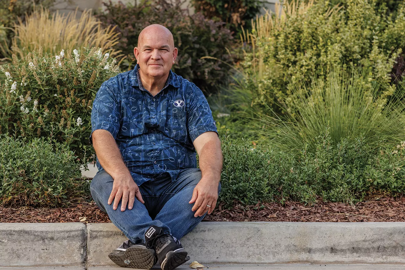 BYU plant and wildlife professor Bryan Hopkins sits outside.