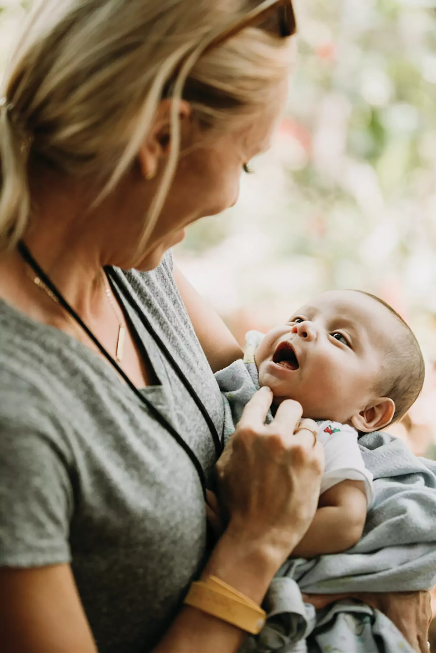 A woman cradles a baby.