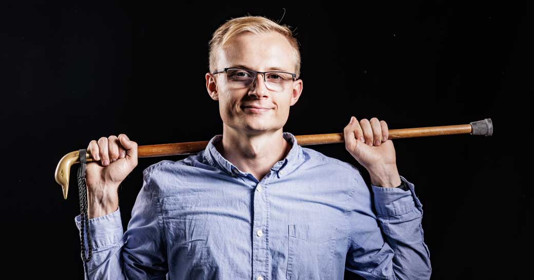 Essay contest winner Isaac Jacob Richards poses with a fashionable wooden cane