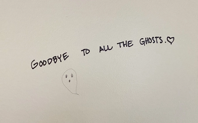 The words "Goodbye to all the ghosts" and a drawing of a ghost on a wall.