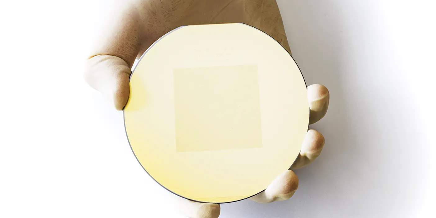 Palm-sized silicon wafer with entire Book of Mormon etched on the surface.