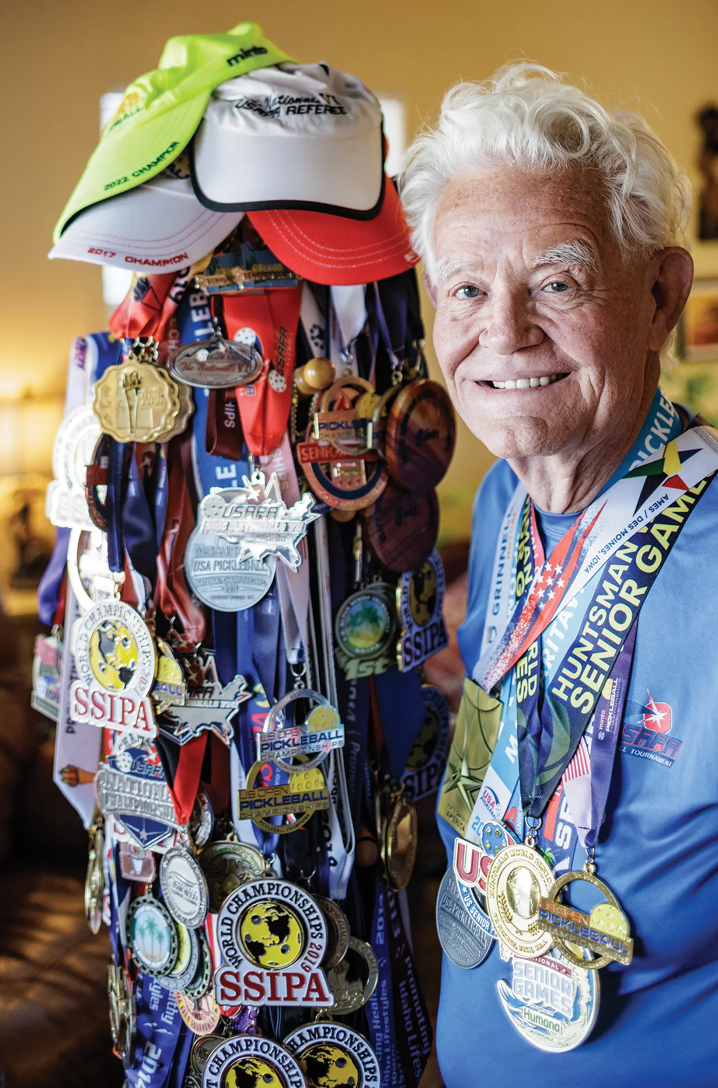 Johnson, grinning, shows off his more than 250 medals, most of them gold.