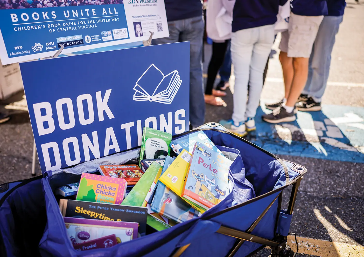 A collection of donated books at a BYU tailgate in Lynchburg, Virginia.