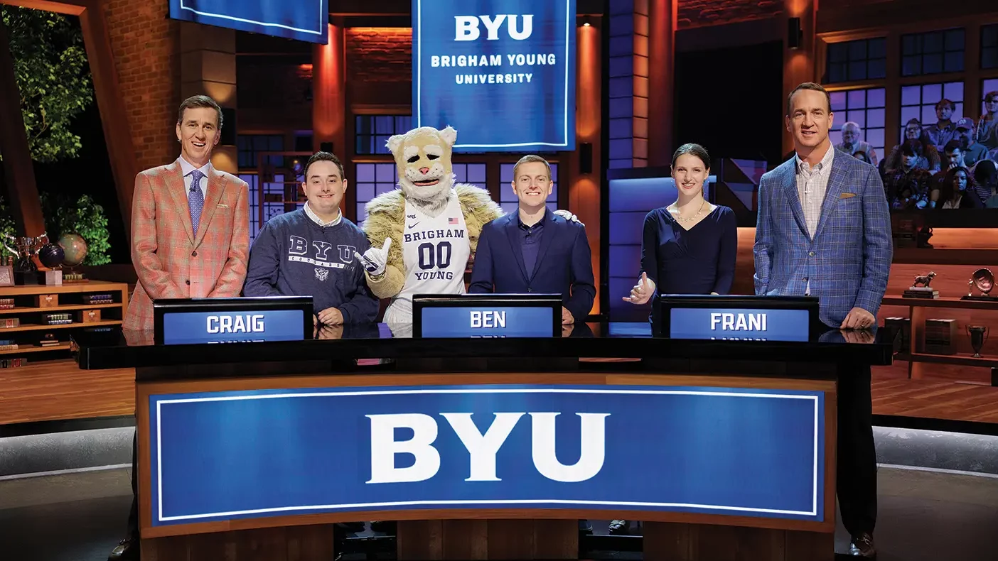 A team of BYU student pose with Cosmo and Peyton and Eli Manning on the set of NBC's College Bowl.