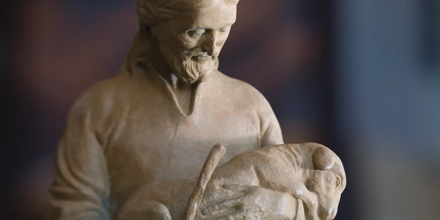 A statue of Jesus holding a lamb.