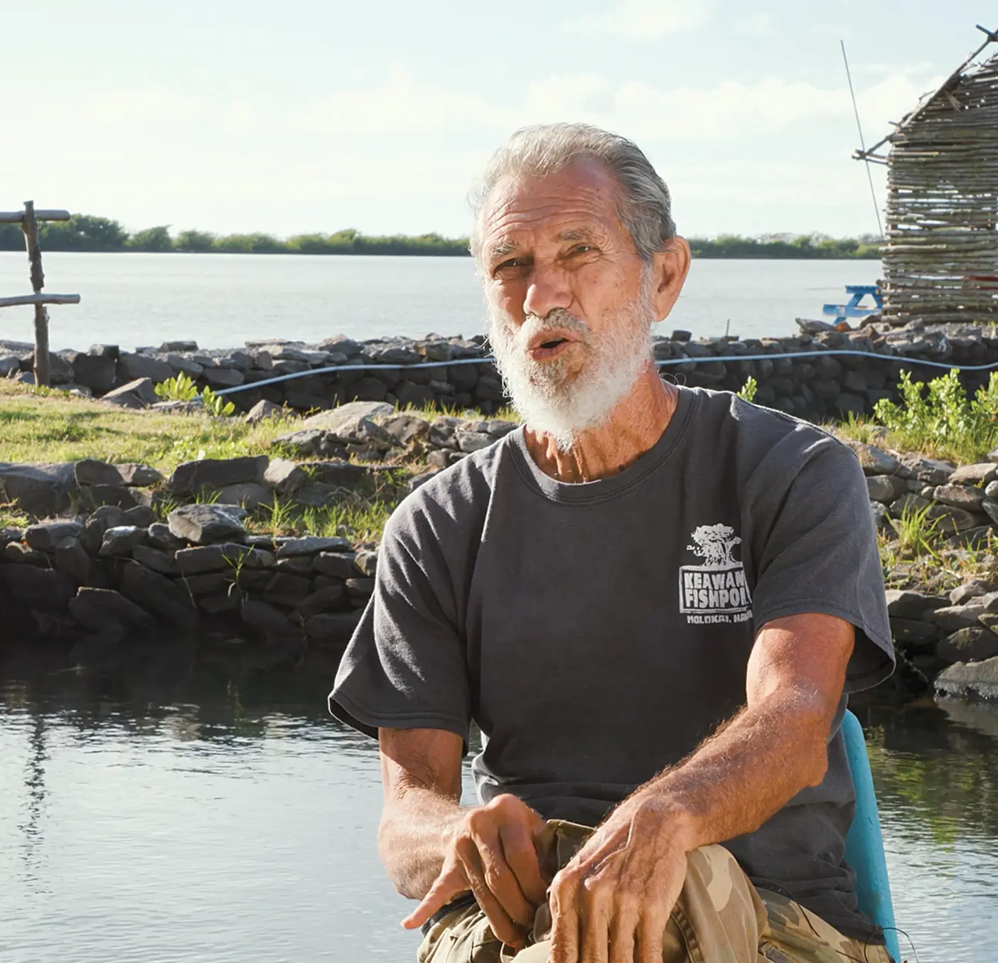 Walter Ritte sits in front of one of Molokai's traditional fishponds.