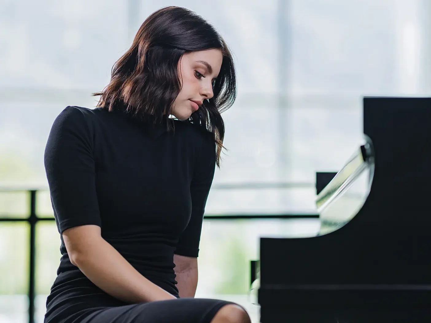 BYU piano grad Savannah Jones poses at a piano in the Music Building on campus.