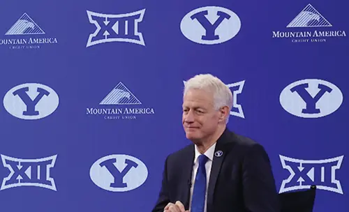 President Worthen in front of a press banner with the Big 12 and BYU logos