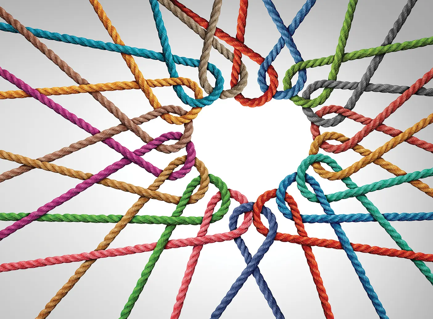 Colorful strings woven together to form a heart shape.