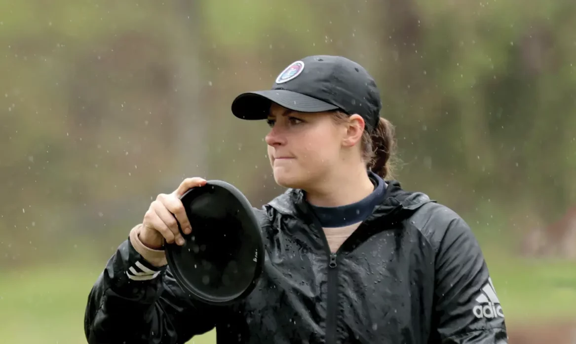 Tailey Rowley, national collegiate disc golf champion, prepares for a toss in the rain