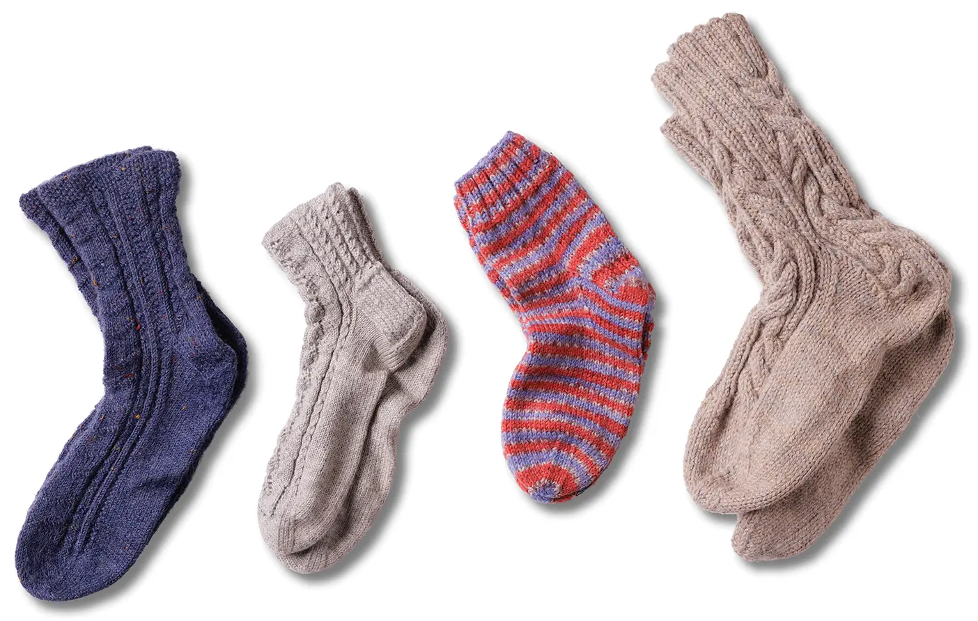 Assortment of hand-knitted woolen socks with cabled designs. 