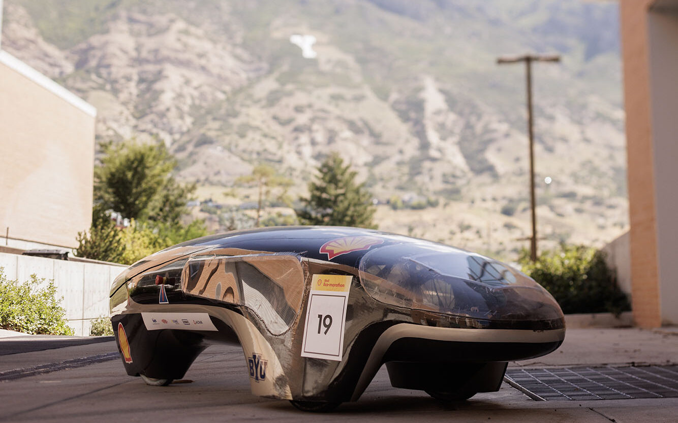 BYU's winning supermileage vehicle sits on campus with Y Mountain in the background.