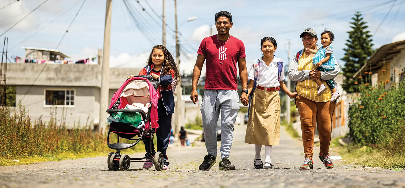 Marcó Gavilanes, his wife, Cinthia, and three of their daughters walk a cobbled street to their neighborhood bus stop in Ibarra, Ecuador.