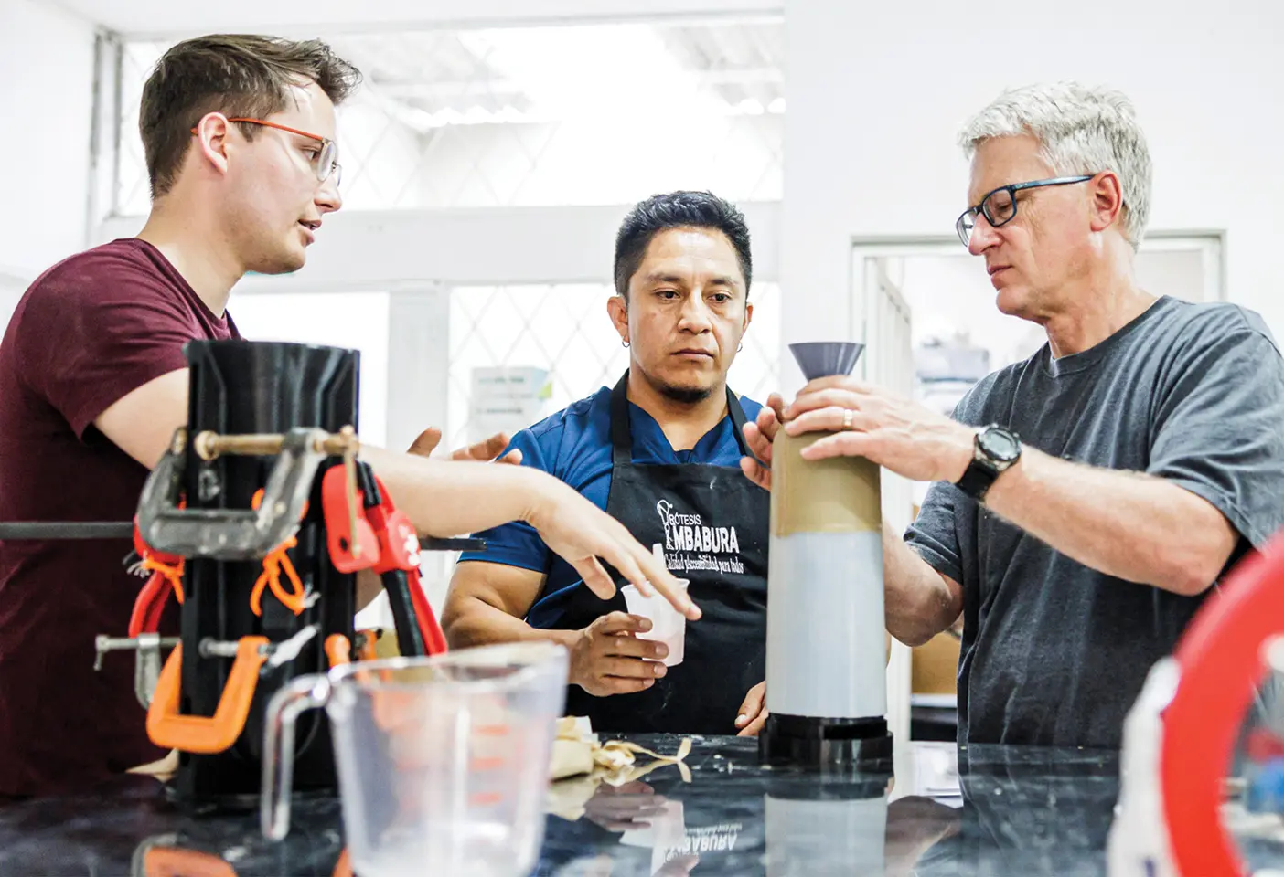 BYU mechanical-engineering
student Daniel R. Budge (’24), prosthetist Jairo Collaguazo, and professor Randy Lewis discuss the process of pouring prosthetic liners using a BYU designed 3D-printed mold.