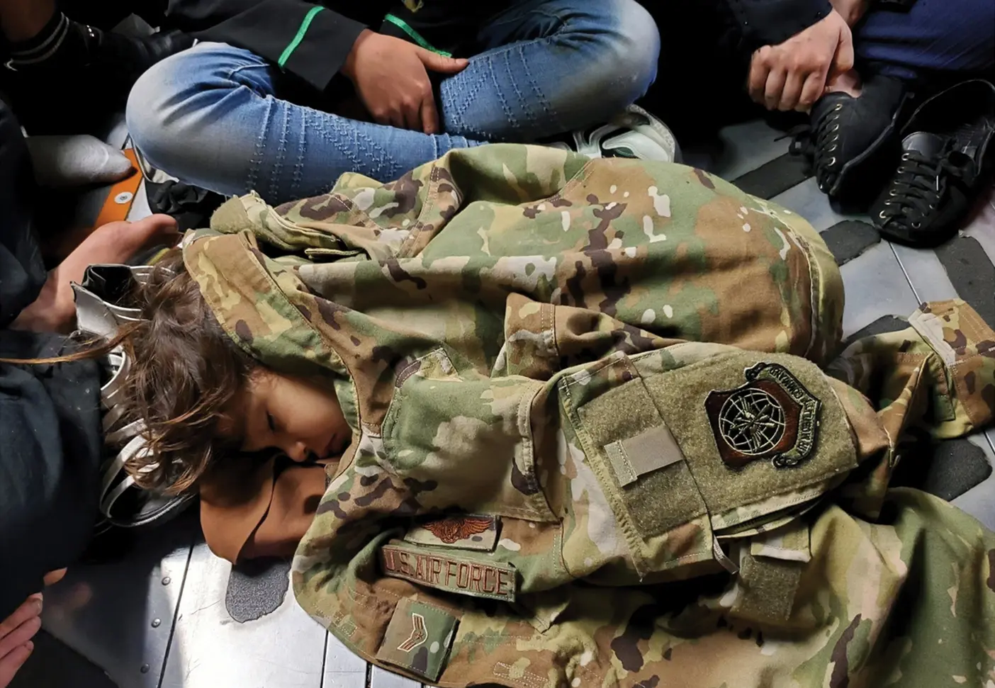 Child sleeping in US Air Force jacket.