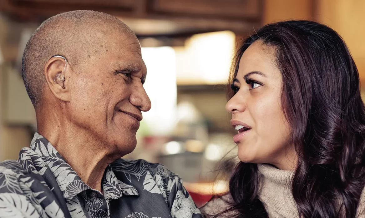 A young woman has a caring conversation with her aging relative.