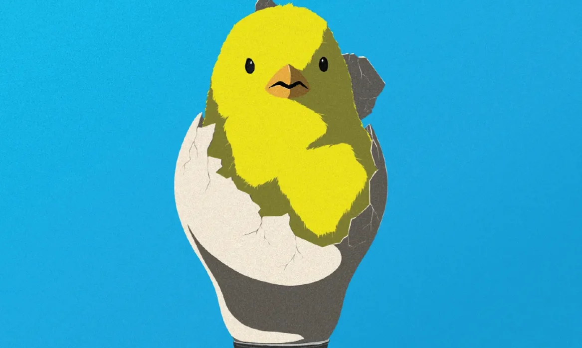 A baby chick hatches out of a lightbulb.
