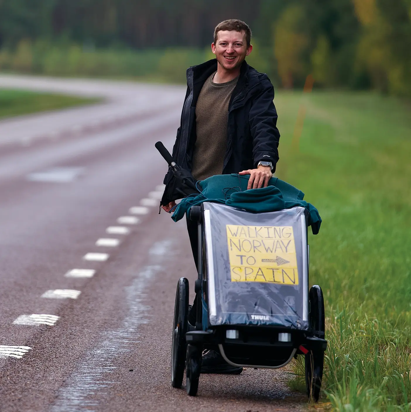 Isaiah Shields on the roadside pushing a cart.