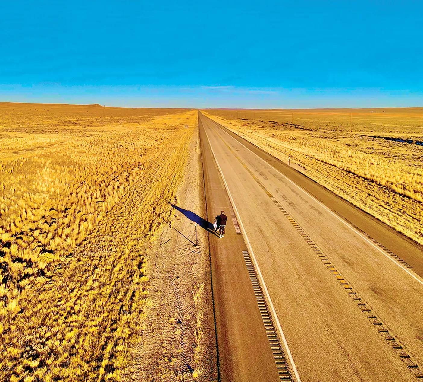 Isaiah Shields walking on a prairie road.
