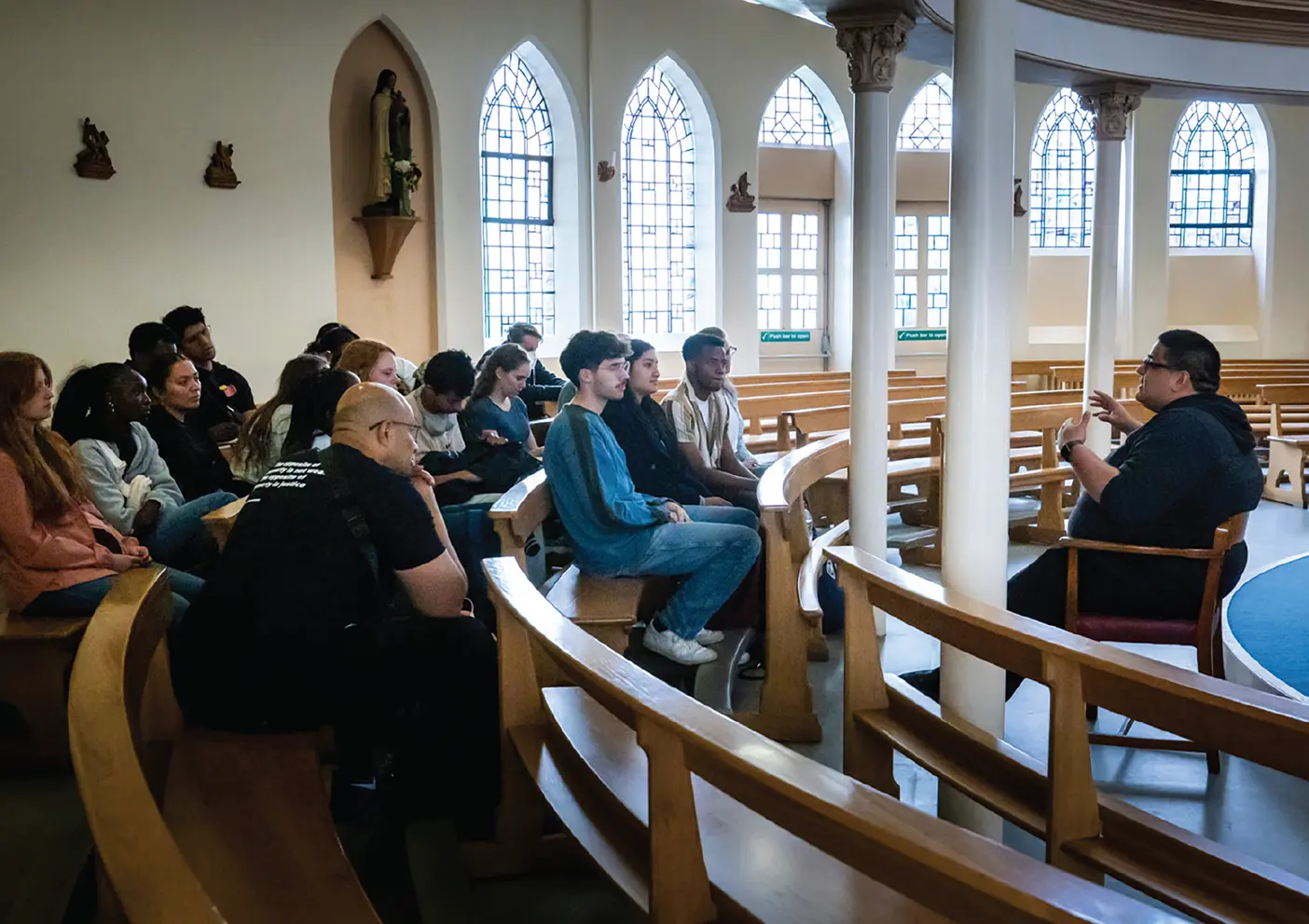 Interfaith-leadership students sit in a church in London.