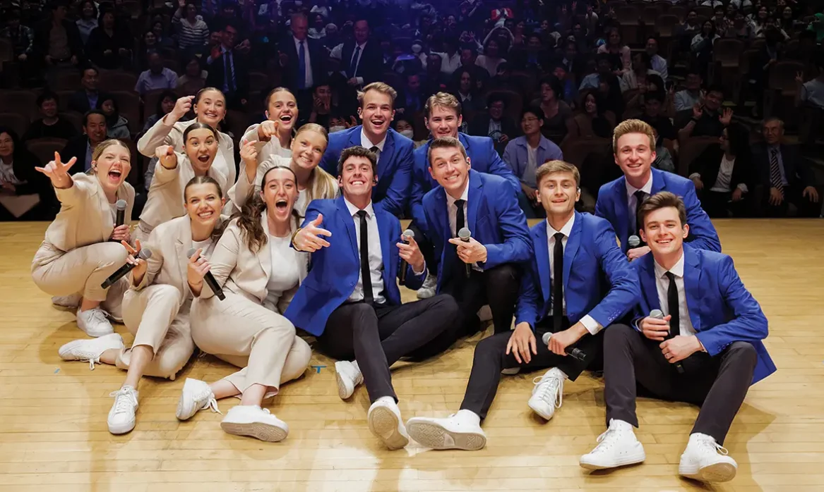 Vocal Point and Noteworthy take a group "selfie" with the audience at one of their shows.