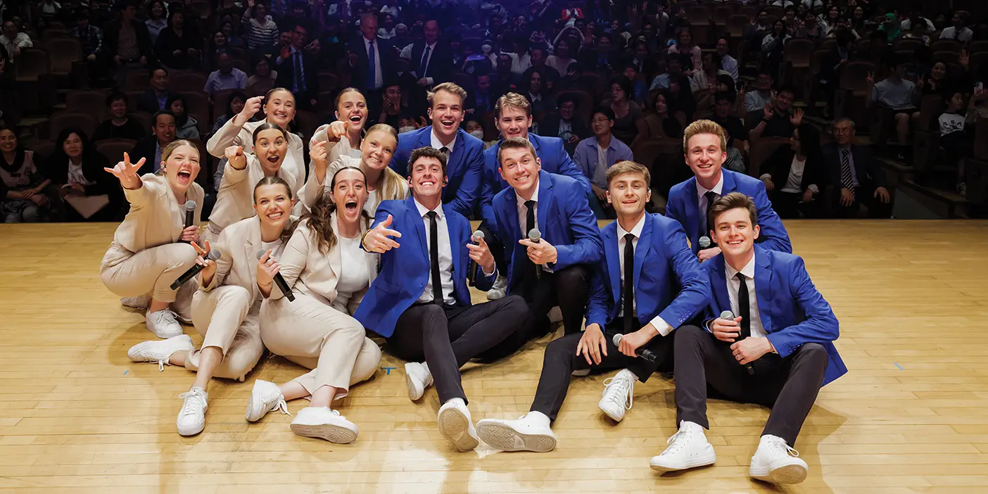 Vocal Point and Noteworthy take a group "selfie" with the audience at one of their shows.