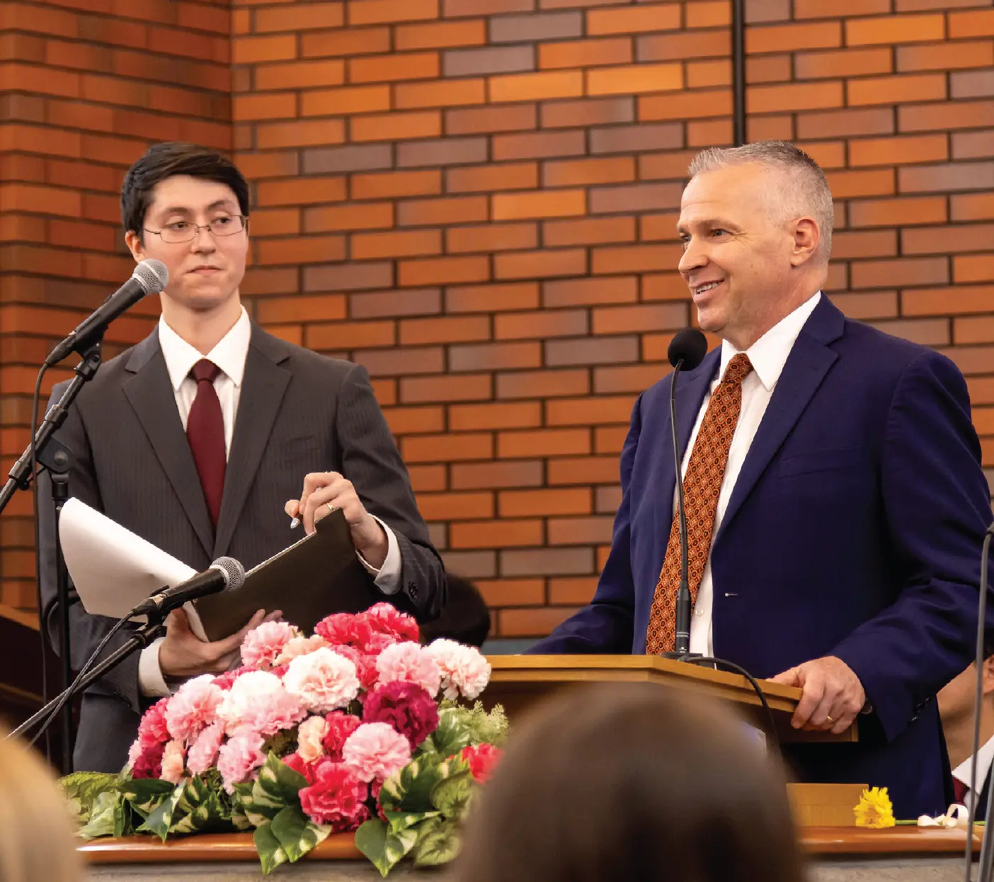 President C. Shane Reese stands at a podium at an LDS church building in Tokyo, Japan.