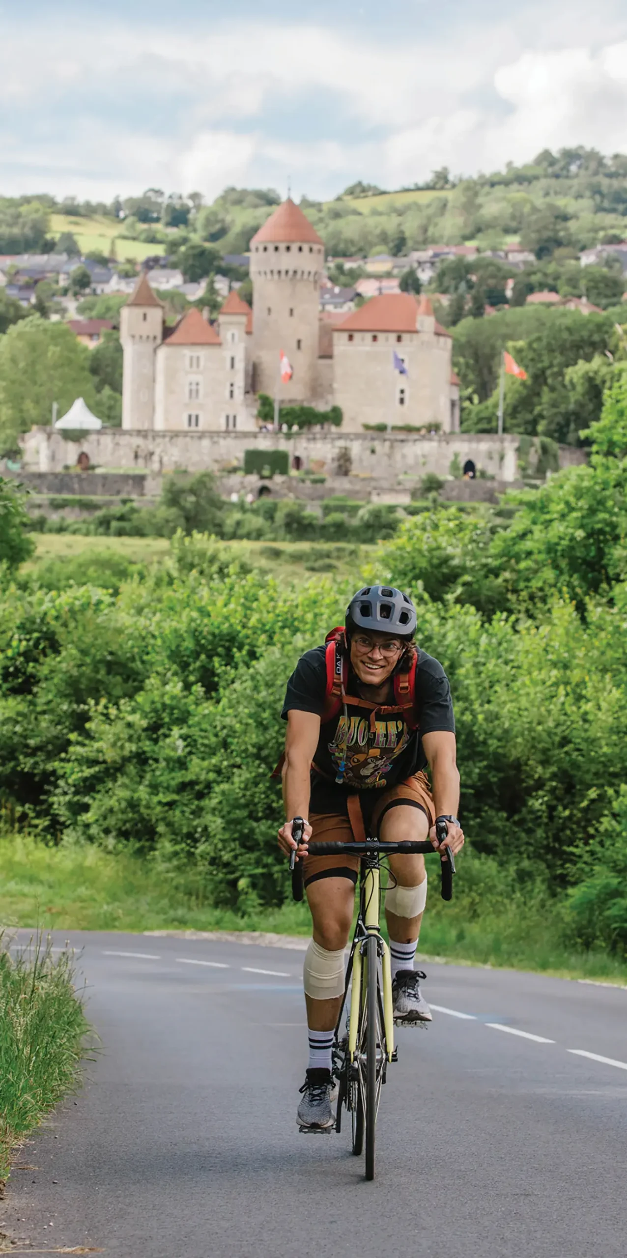 Alex Gillen riding a bike in in front of a castle in Germany.