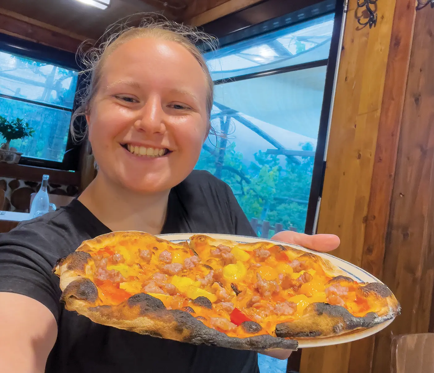 BYU student Emily Knote holding a pizza in Italy.