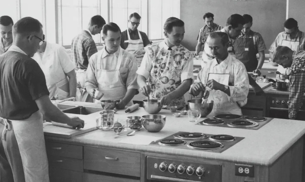 Students in a culinary classroom learn and bake together.