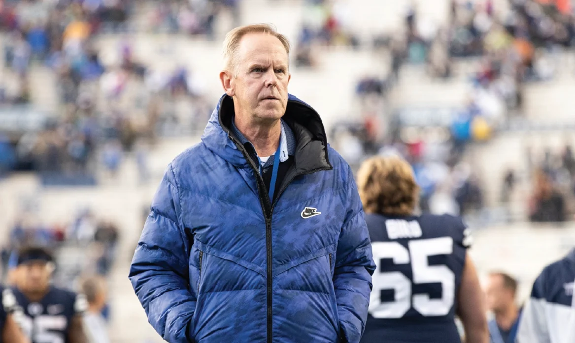 Tom Holmoe BYU athletic director in a blue puffer coat at a football game
