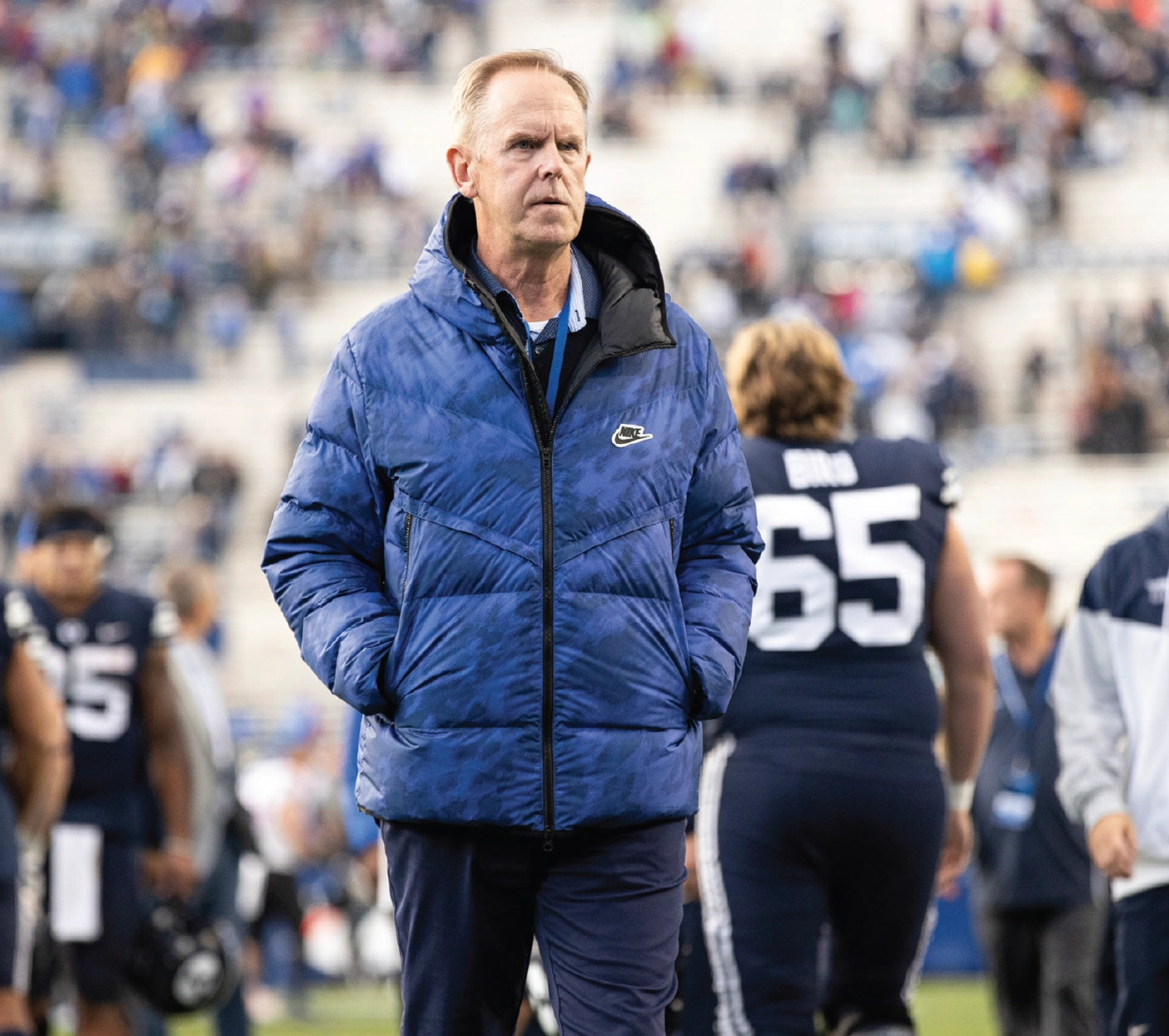 Tom Holmoe BYU athletic director in a blue puffer coat at a football game