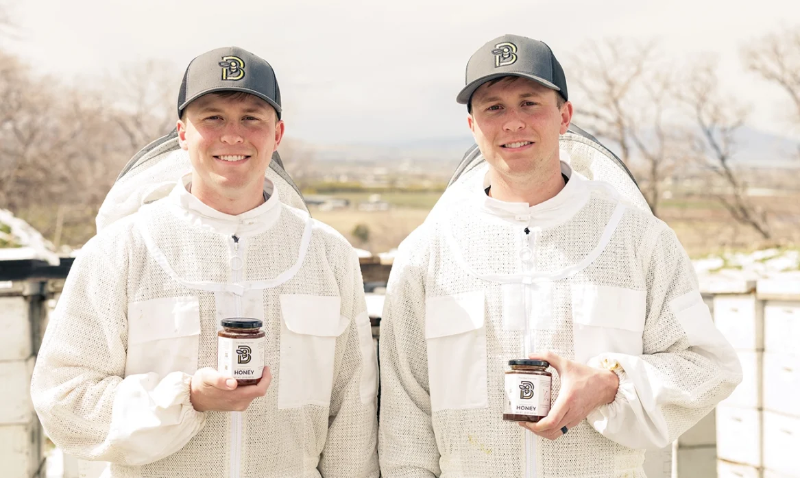 Jed and Jake Poulsen in beekeeping suits
