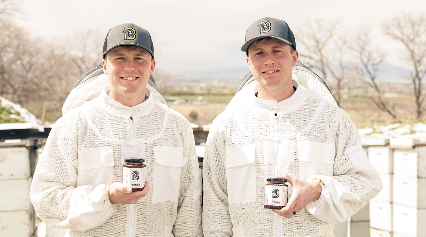 Jed and Jake Poulsen in beekeeping suits