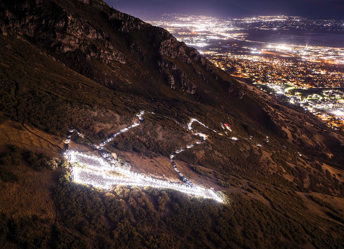 Bright white lights from the Y on top of the mountain at night.
