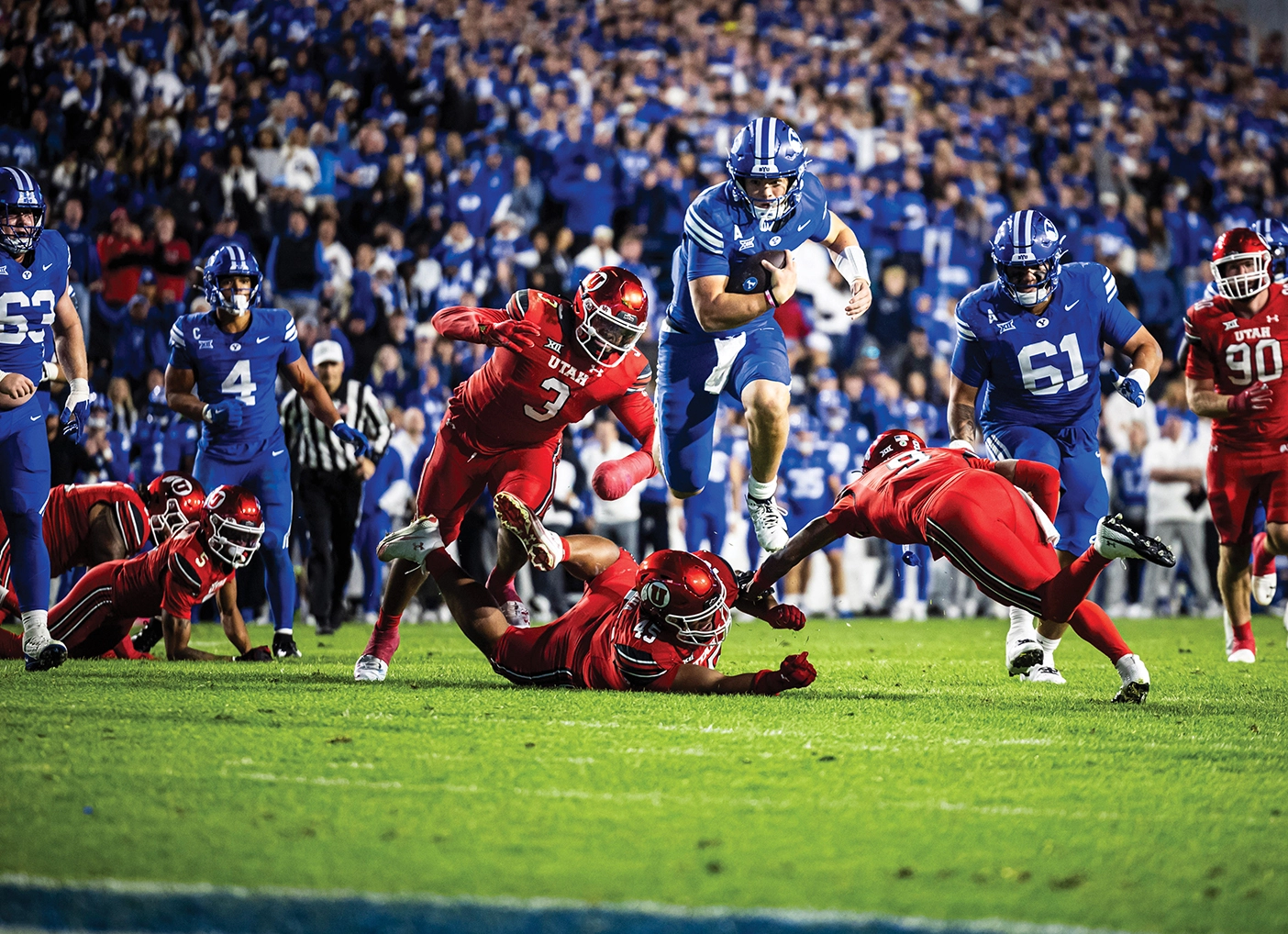 Bear Bachmeier pictured leaping over a Utah defensive tackle as he ran through the defense for a 22-yard touchdown. 