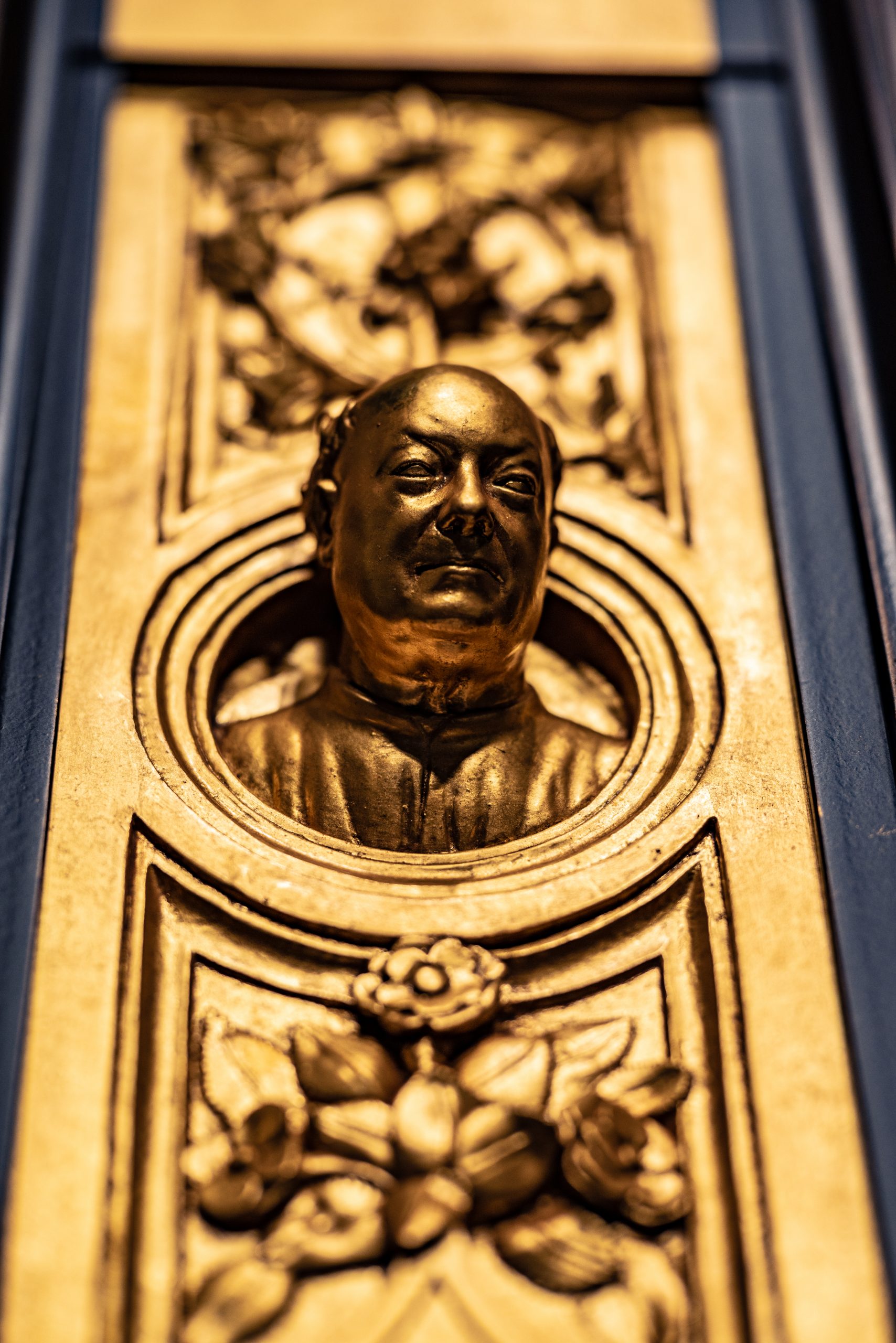 One of the panels from the Gates of Paradise includes a self-portrait of the artist, Lorenzo Ghiberti, as a golden bust with ornate flowers above and below his head.